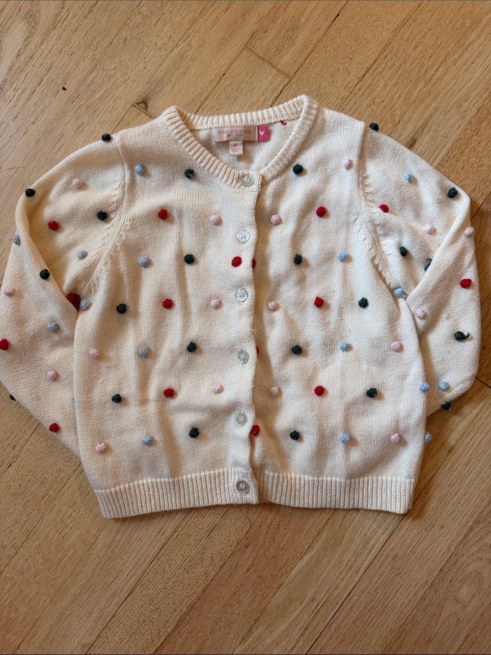 Pink Chicken Cream Knit Cardigan with Multicolor Pom Accents